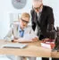 Employees in a law firm look at a printed document.