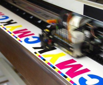 A large-format printer doing a test print.