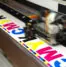 A large-format printer doing a test print.