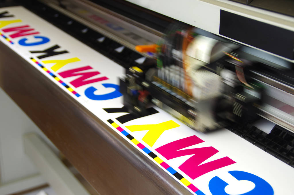 A large-format printer doing a test print.