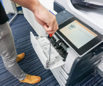 A technician fixing a printer.