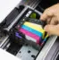An individual taking out a printer cartridge.