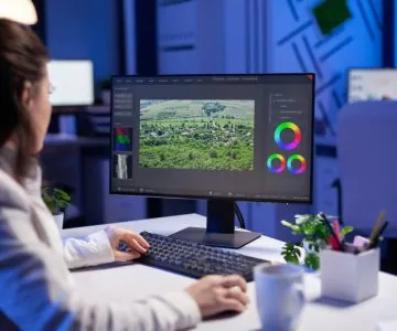 A woman preparing images for large-format printing.