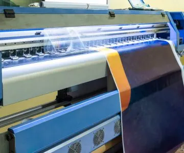 A large-format printer printing a banner.